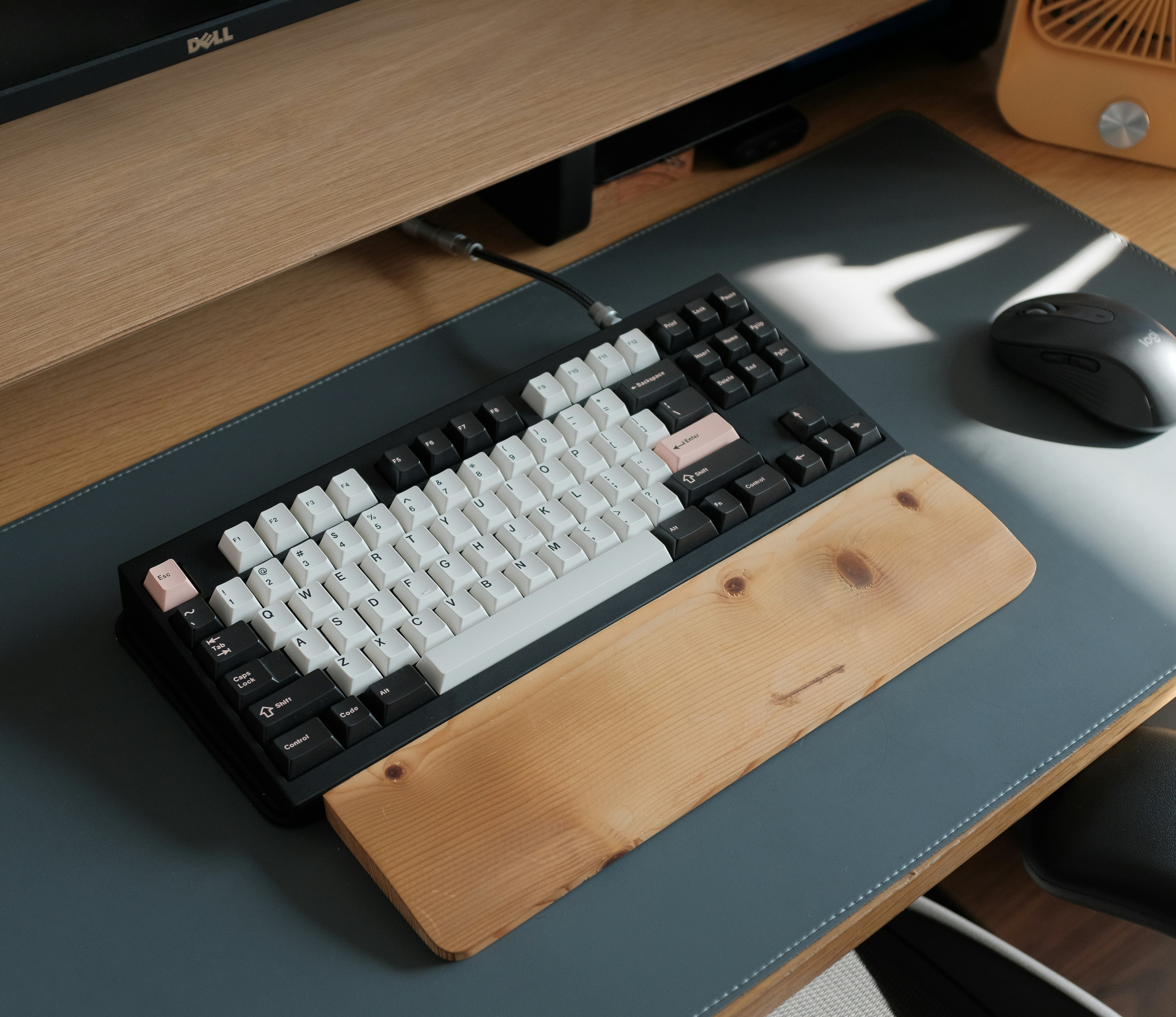 JavaScript Monorepo - a computer keyboard sitting on top of a wooden desk